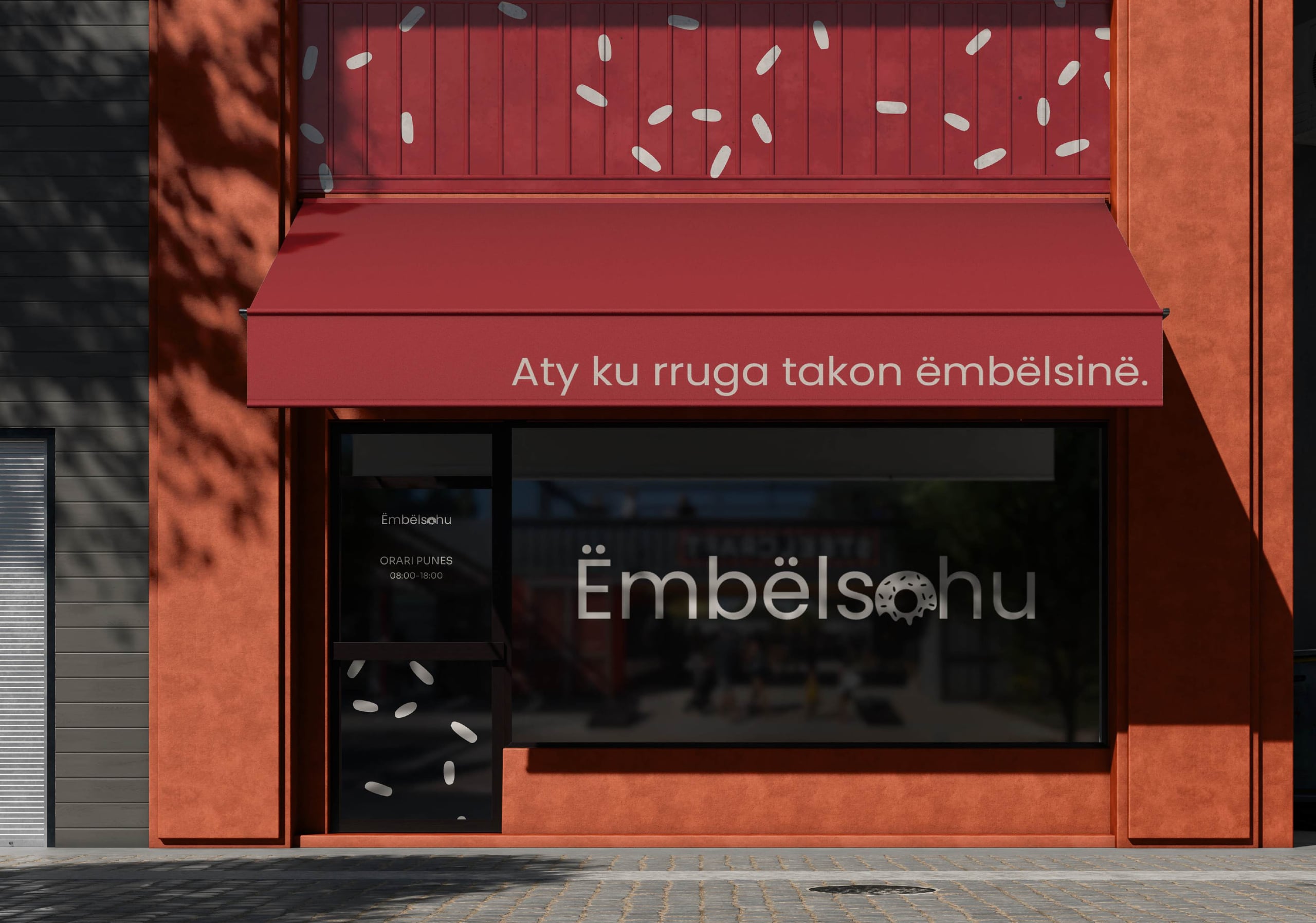 Embëlsohu shopfront with a red awning and the motto “Where the street meets sweetness.”